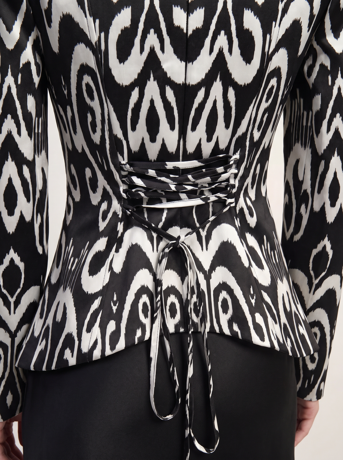 Sadri Couture Marvorid Top, an ikat-print structured top with a square neckline, close-up of fabric and hardware detail.